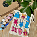 It's a Party Tic-tac-toe set with painted hens party pieces on a calico board, paint pots and brush